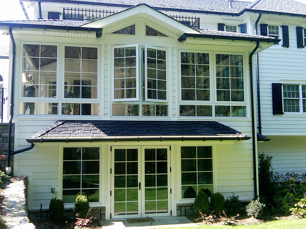 Multiple European window/wall systems in one home. French doors, curtain walls and casement windows used in traditional construction. Units showcase SDL grids.