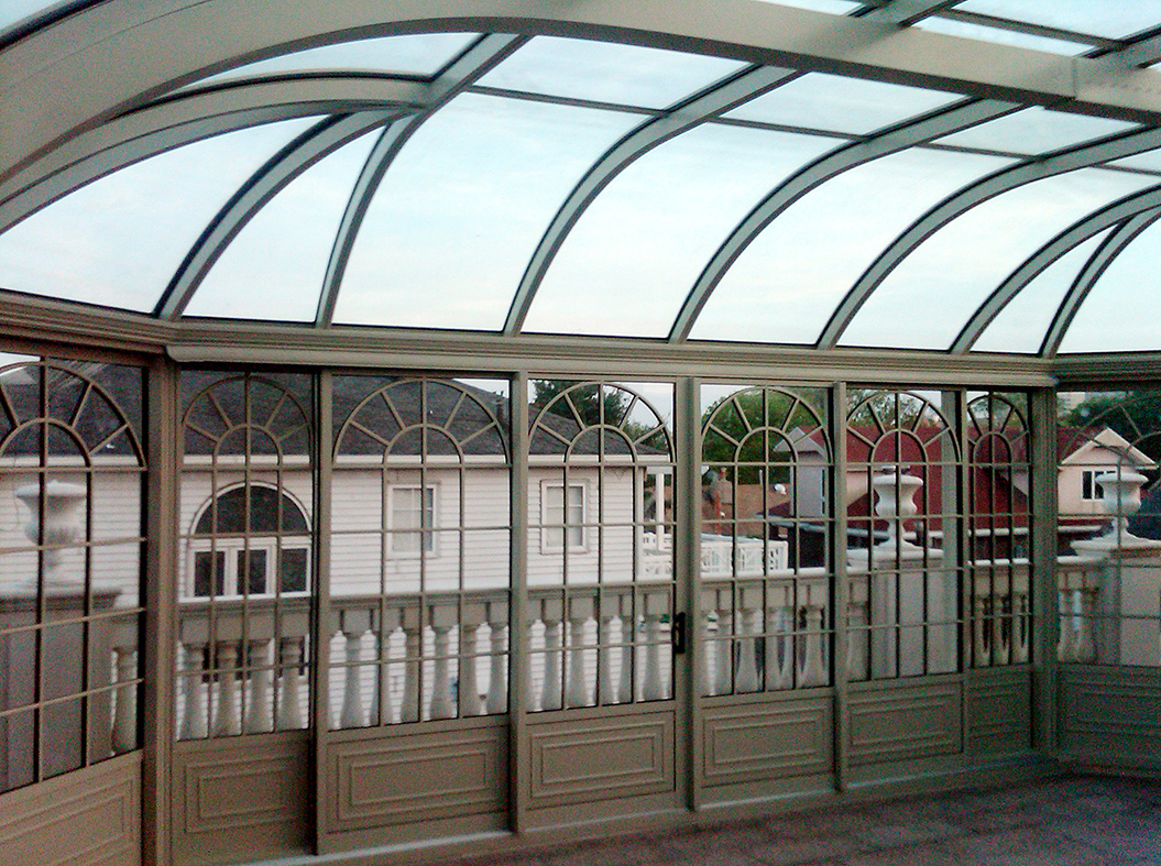 Curved eave pool enclosure with sliding glass doors