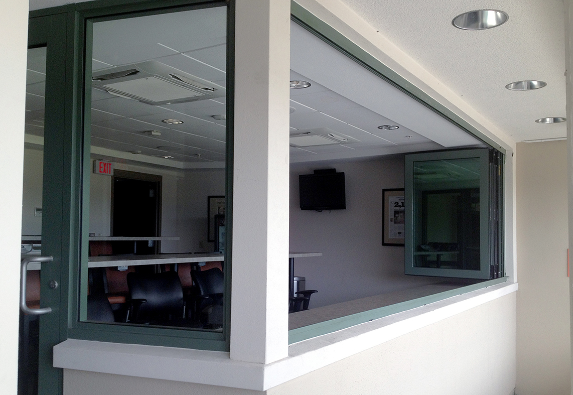 Three sets of folding glass windows used on a stadium project. The units have a standard sill and monolithic impact glass.