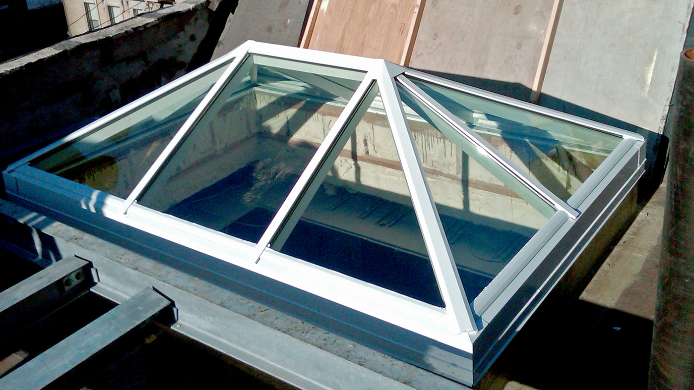 Flat welded curb skylight and straight eave double pitch skylight.