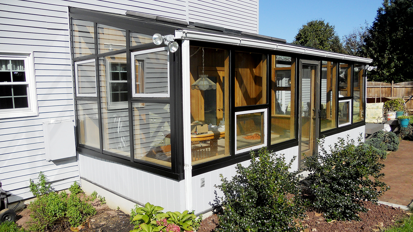 Flexible glazing system applied to an existing wood sunroom members.