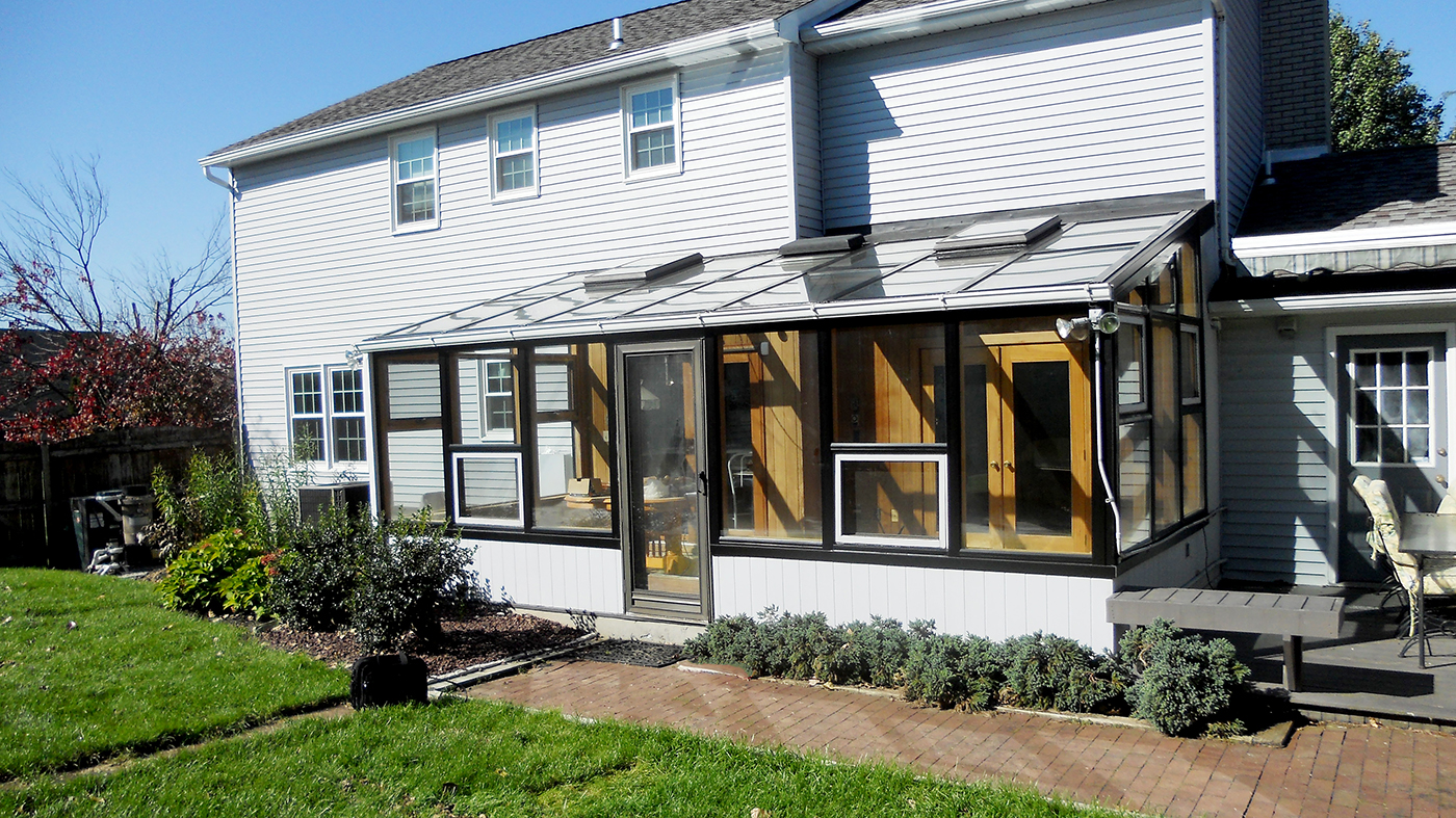 Flexible glazing system applied to an existing wood sunroom members.