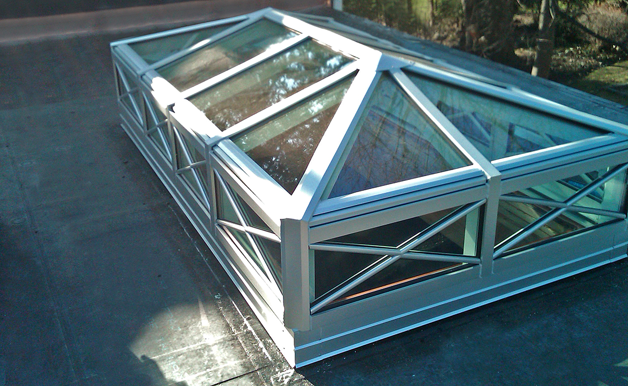 Double pitch skylight with two gable ends and transom.