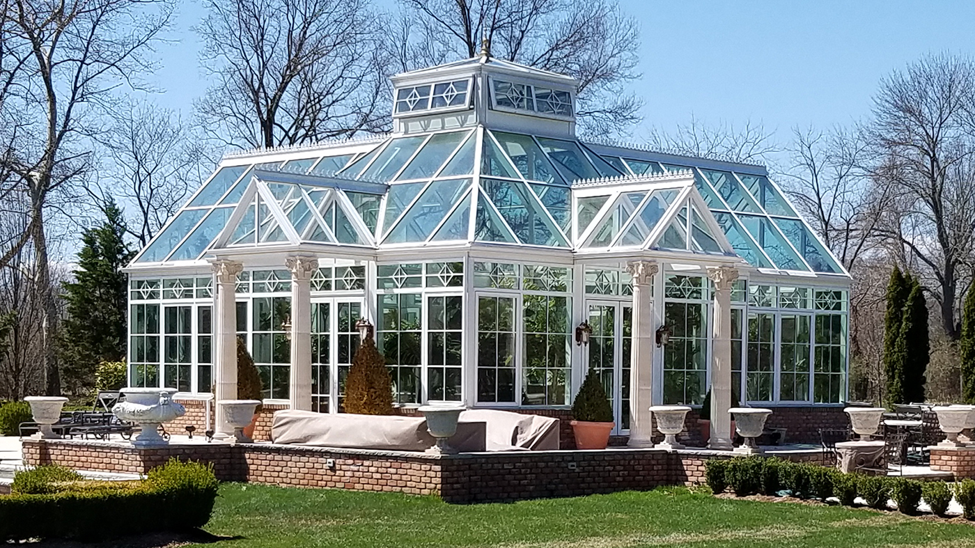 Straight eave pyramid conservatory with four double pitch lanterns, two interior partitions, transoms, gridwork, gable rake molding, gutter, downspout and a pyramid lantern.
