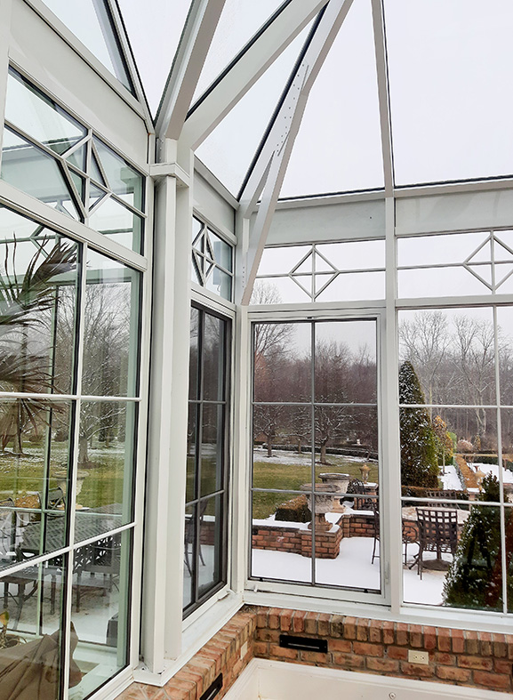 Straight eave pyramid conservatory with four double pitch dormes, two interior partitions, transoms, gridwork, gable rake molding, gutter, downspout and a pyramid lantern. Linear actuator motor shown.