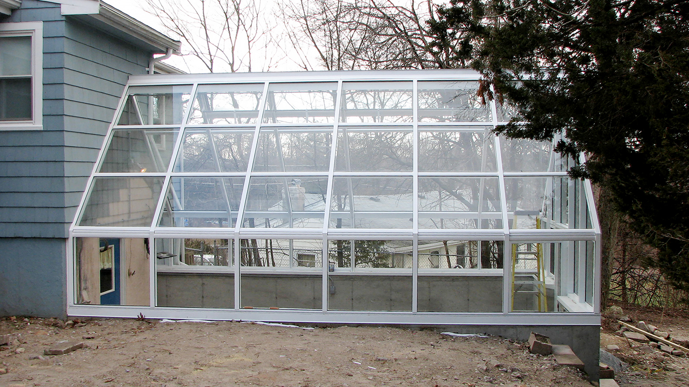 Straight eave double pitch greenhouse with one gable end.