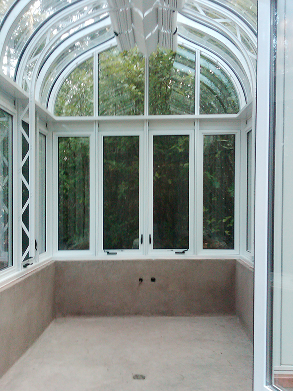 Ogee double pitch conservatory with two gable ends including decorative cresting, finials, gutters, interior truss and roof mounted operable shades.