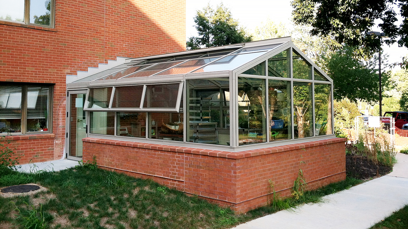 Straight eave double pitch greenhouse with one gable end and eave and ridge vents.