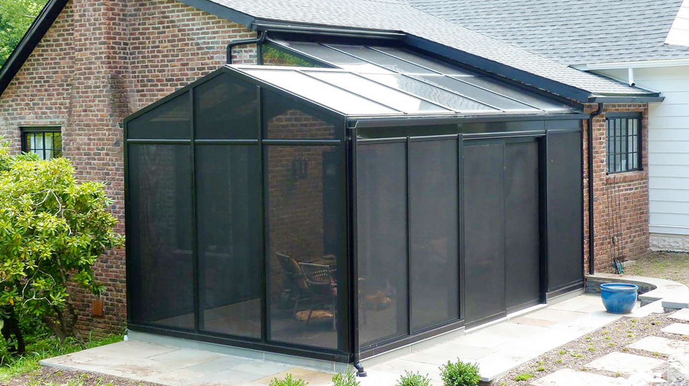 Irregular straight eave double pitch screened-in sunroom with a straight leave lean-to section, glass roof, specialty pet screen walls and sliding doors