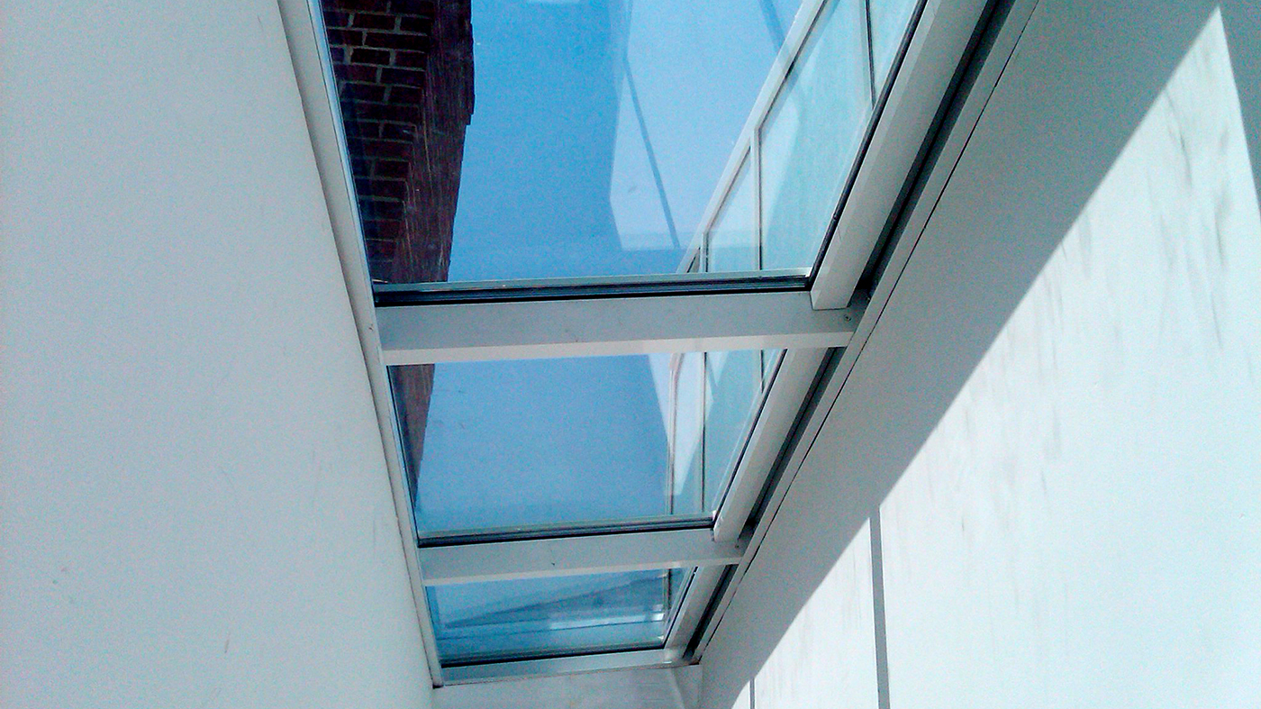 Straight eave lean to single slope skylight with entryway