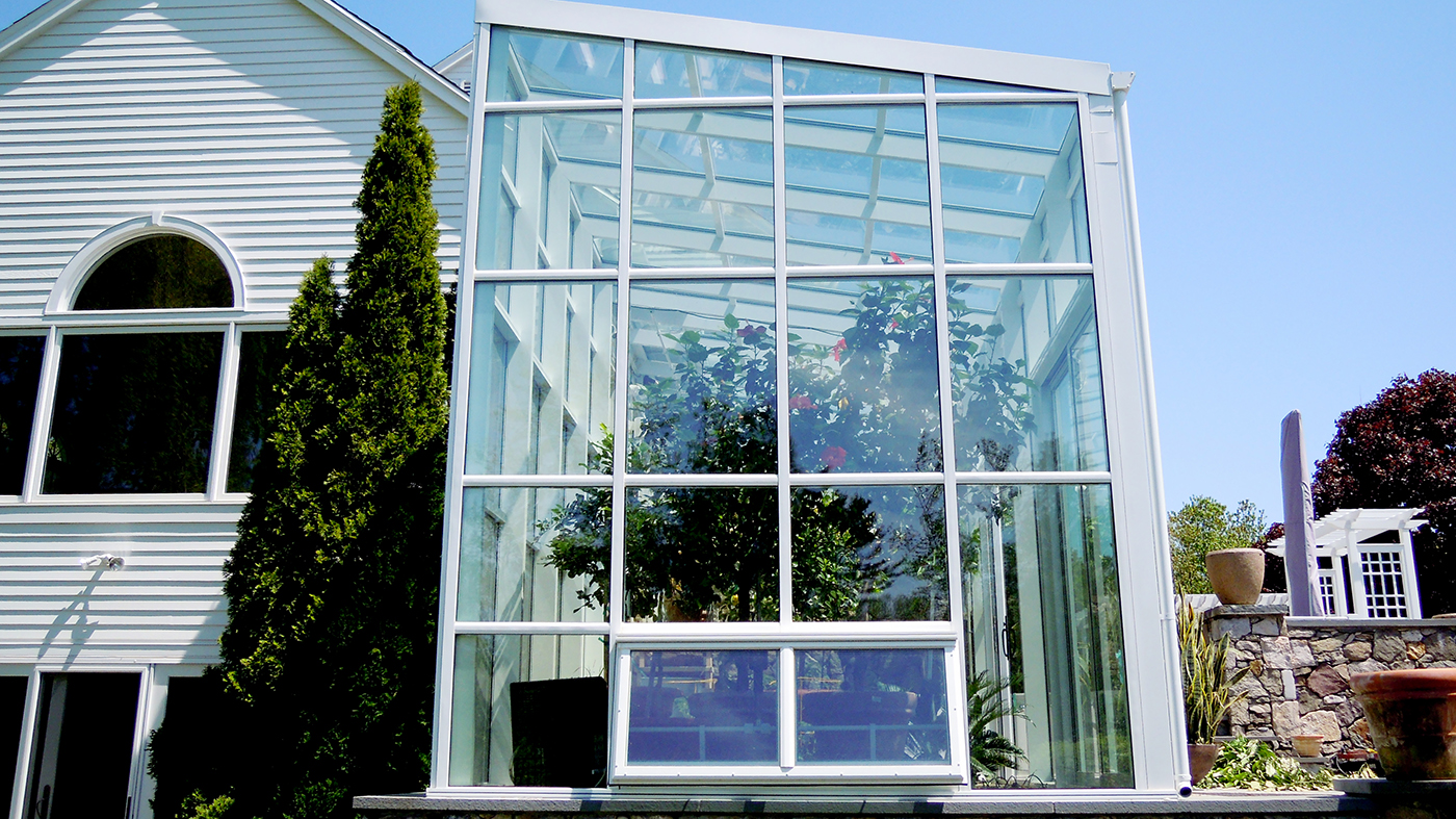 Straight eave lean to greenhouse with two gable ends, ridge vents, eave vents, terrace door, sliding door, heater, circulation fan and aluminum tube plant hanger.