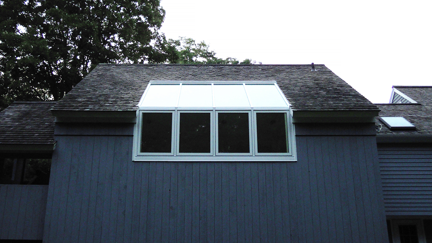 Straight eave lean to skylight with no gable ends, four casement windows and interior Douglas fir veneer.