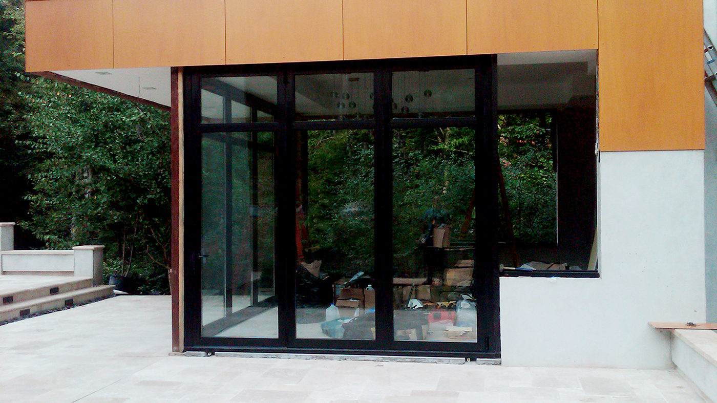 Three sets of bifold doors and two aluminum curtain walls