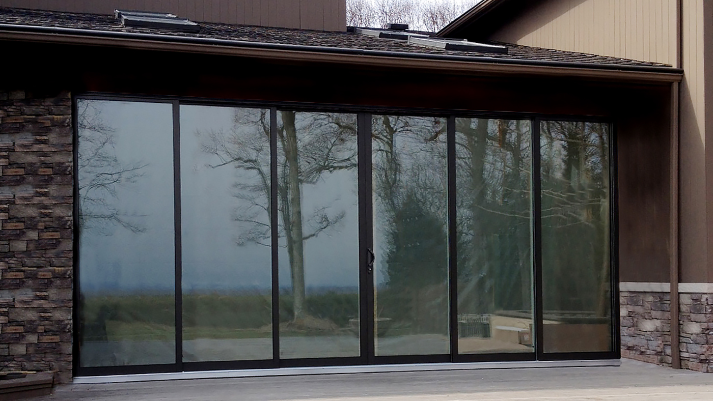 Multi track sliding glass door with OXXXXO configuration and two tone frame finish.