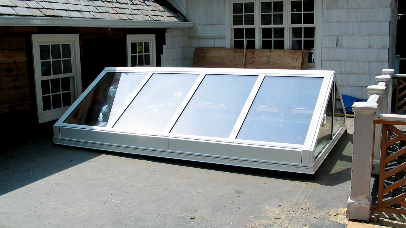 Straight eave, double pitch skylight with Mahogany interior.