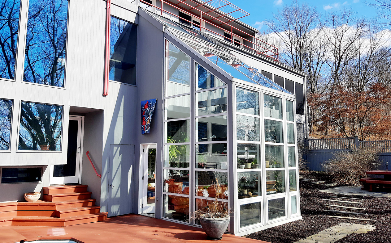 Straight eave lean-to greenhouse with chain-drive operable ridge vents and awning windows