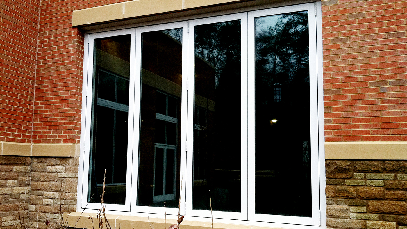 Folding windows on an institutional dining room to open the room to fresh air.