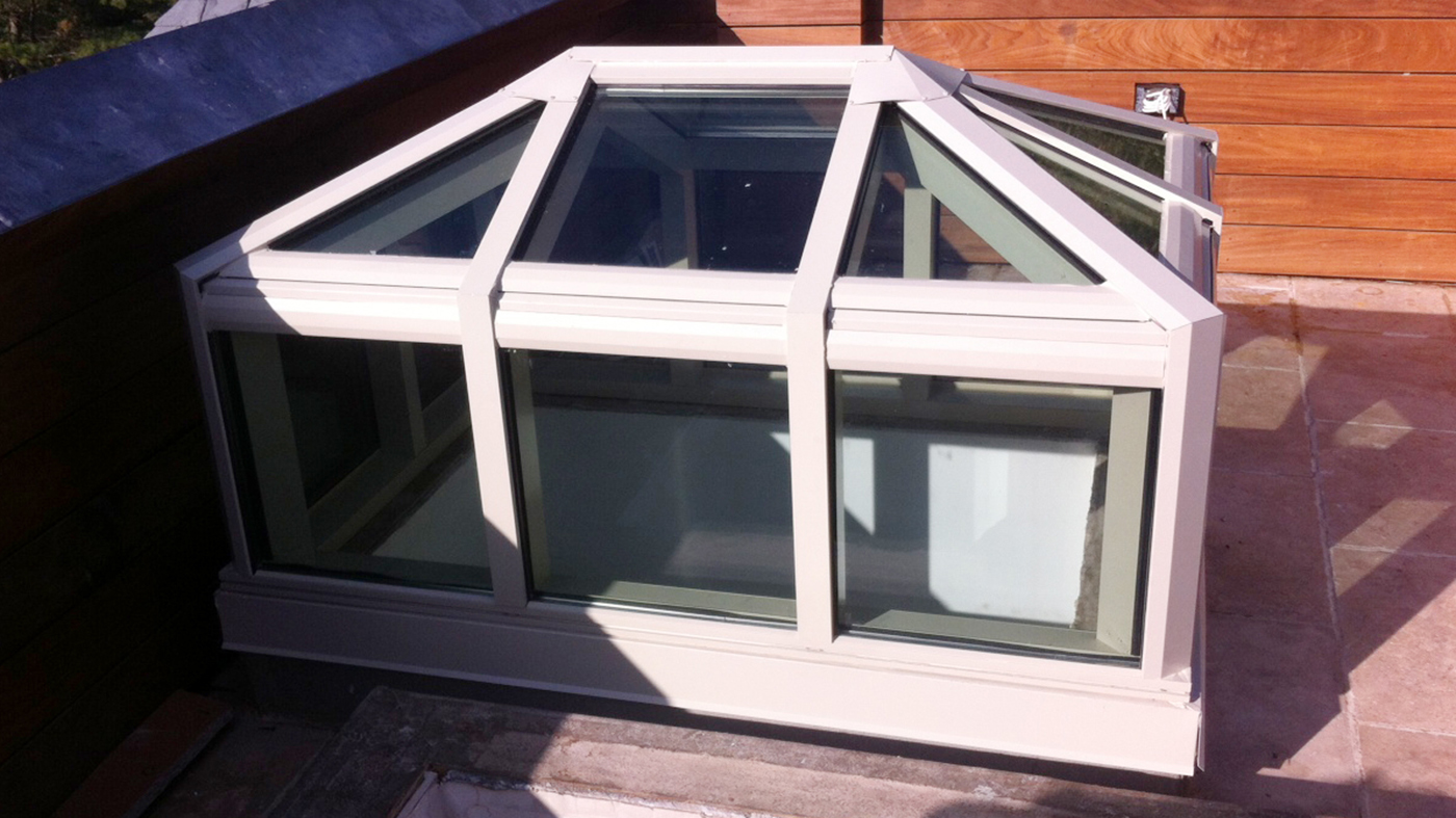 Hip end double pitch skylight with transom