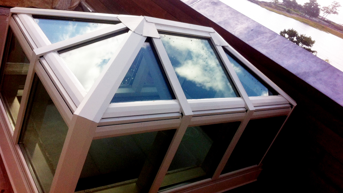 Hip end double pitch skylight with transom