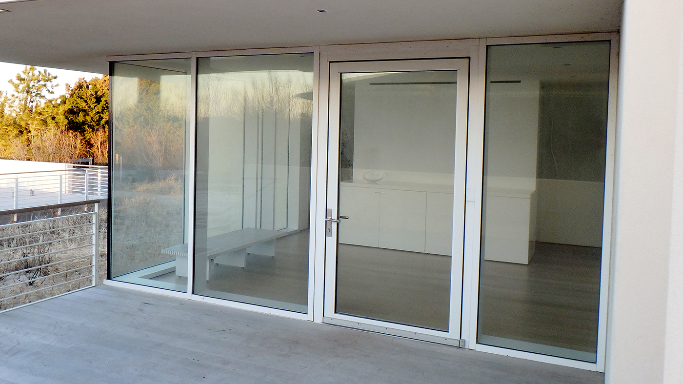 Complete Glazing Package features multiple curtain wall systems, a in-swing terrace door, and multiple sliding glass door systems.