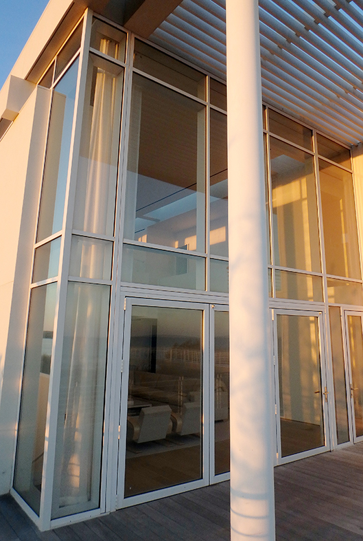 Complete Glazing Package features multiple curtain wall systems, a in-swing terrace door, and multiple sliding glass door systems.