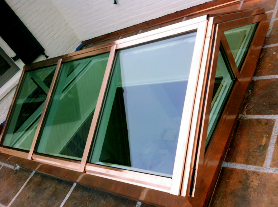 One straight eave, double pitch skylight with two gable ends featuring a Copper cladding exterior finish.
