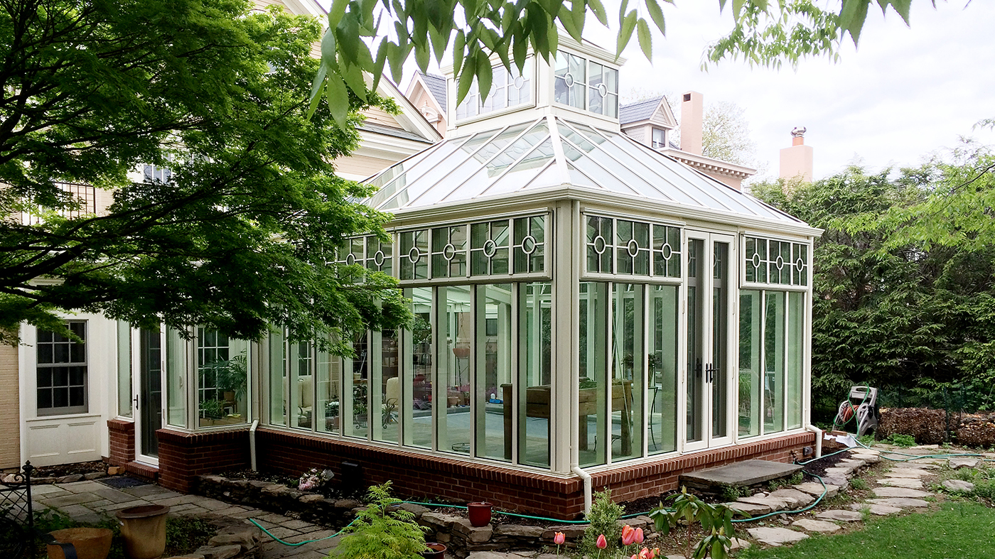 A pool enclosure with 2 hip ends and a hip end cupola.