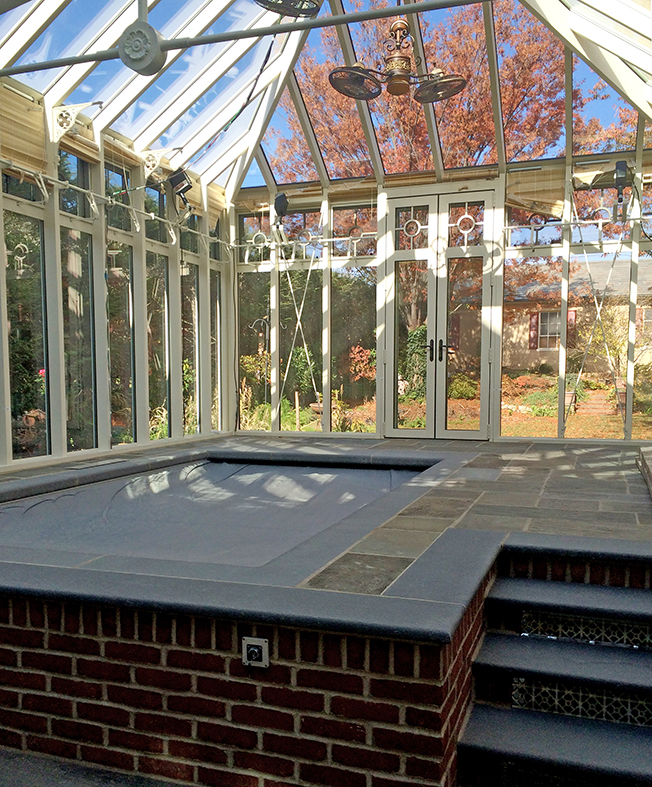 A pool enclosure with 2 hip ends and a hip end cupola.