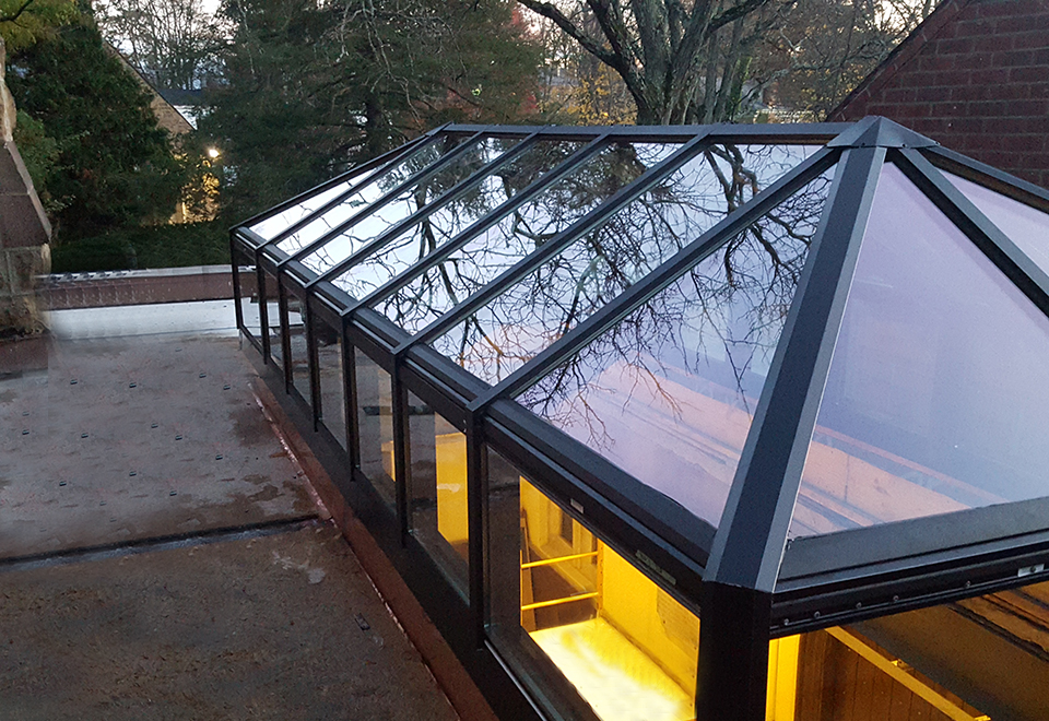 This aluminum double-pitch transom skylight was installed in a commercial setting. This type of skylight allows daylight to enter a space as well as a view of the outdoors.