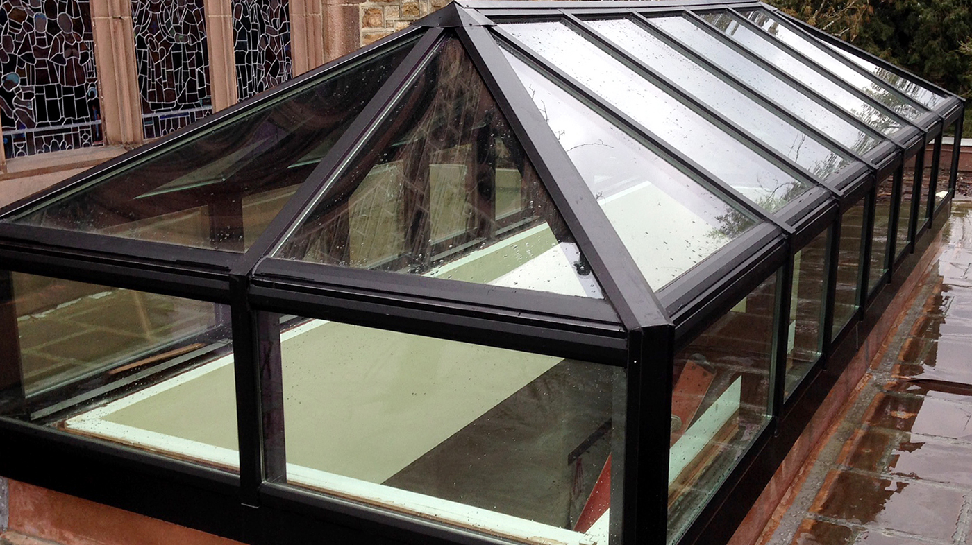 This aluminum double-pitch transom skylight was installed in a commercial setting. This type of skylight allows daylight to enter a space as well as a view of the outdoors.