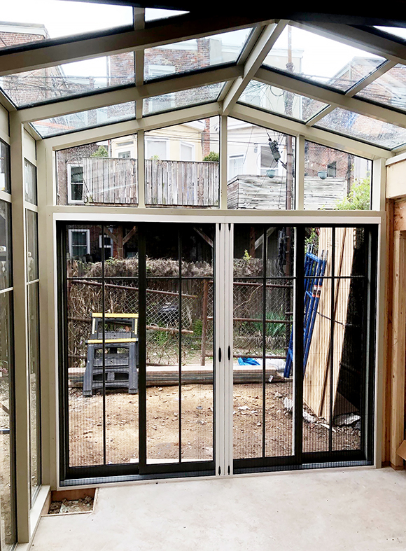 Straight eave double pitch sunroom with multi-track sliding glass doors and B-Series screens