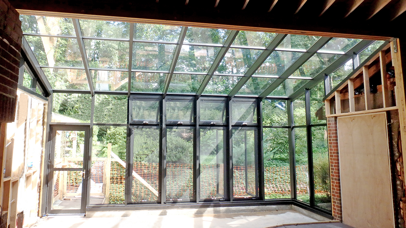 Straight eave lean-to sunroom with four awning and casement windows and one terrace door