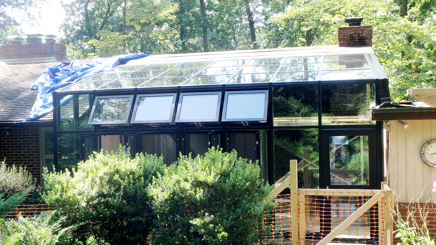Straight eave lean-to sunroom with four awning and casement windows and one terrace door