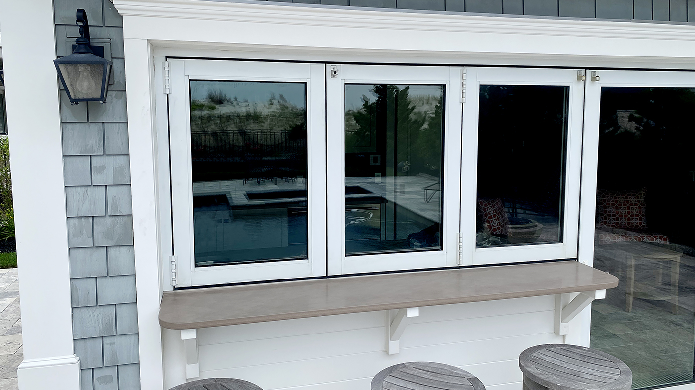 One six-panel single door mid-wall bifold door unit with half the system used as a window and the other half used as a door.