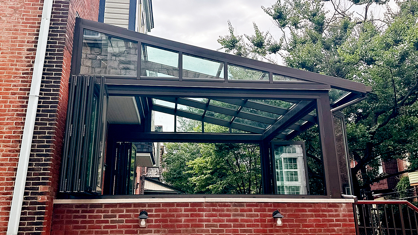 Straight eave lean-to sunroom/skylight with two 5-panel G2 outfold all-wall bifold window units and one four-panel G2 outfold  single door hinged jamb (SDHJ) bifold door unit incorporated into the design.