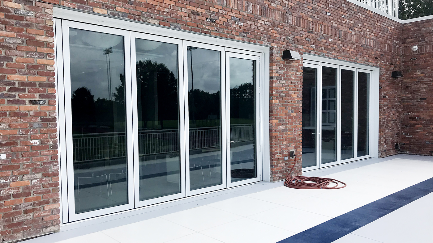 Slide and Stack Wall Systems with Outswing Single Door