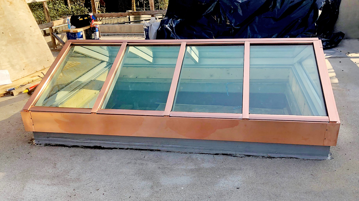 Two straight eave double pitch copper-clad skylights (one pictured)