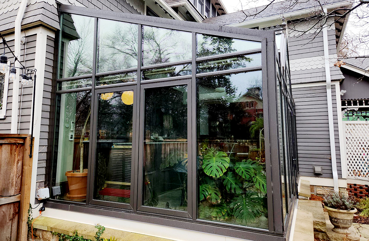 Straight eave lean-to conservatory with an integrated French door, awning windows, and dormer.