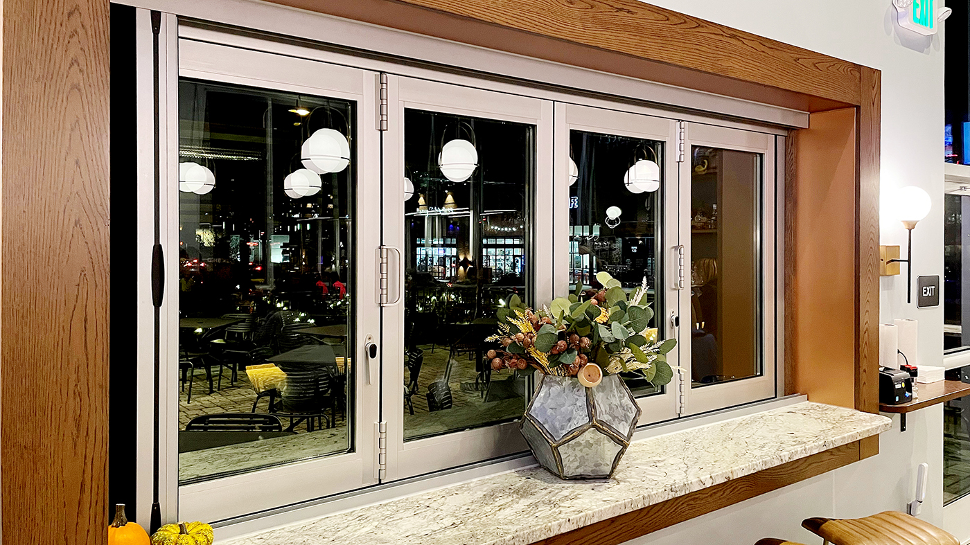 One four-panel G2 outfold all-wall bifold window unit with a B-Series screen system.