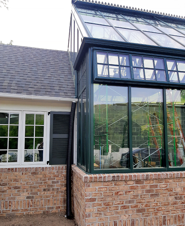 Straight eave double pitch greenhouse with a dormer, built into a slope with a weather station