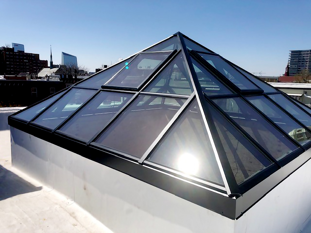 Pyramid skylight with integrated motorized ridge vents