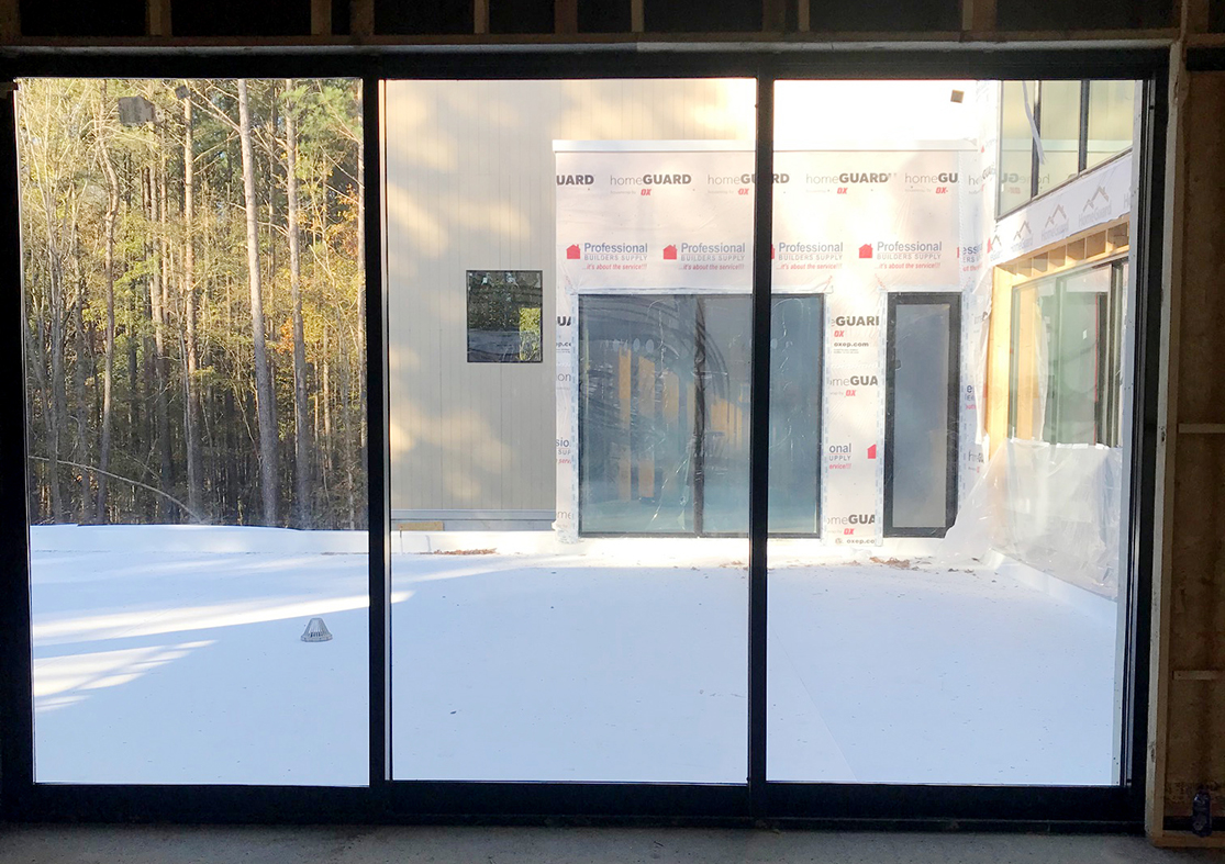 Three sets of multi-track sliding glass doors.