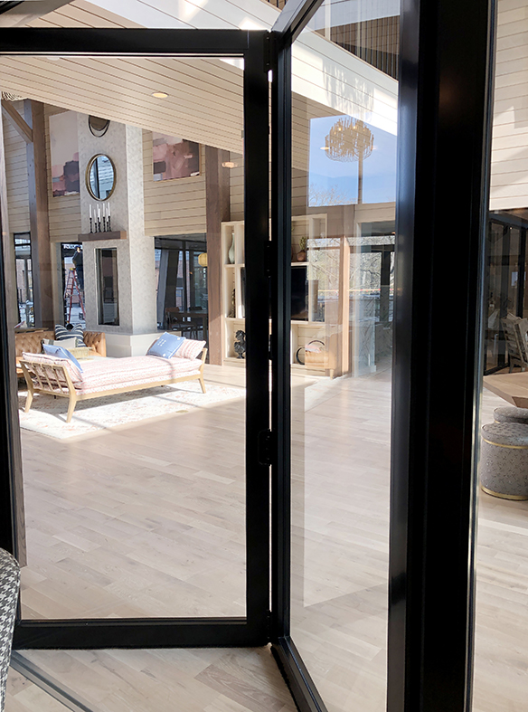 Two bifold door systems with two-point locking handle details