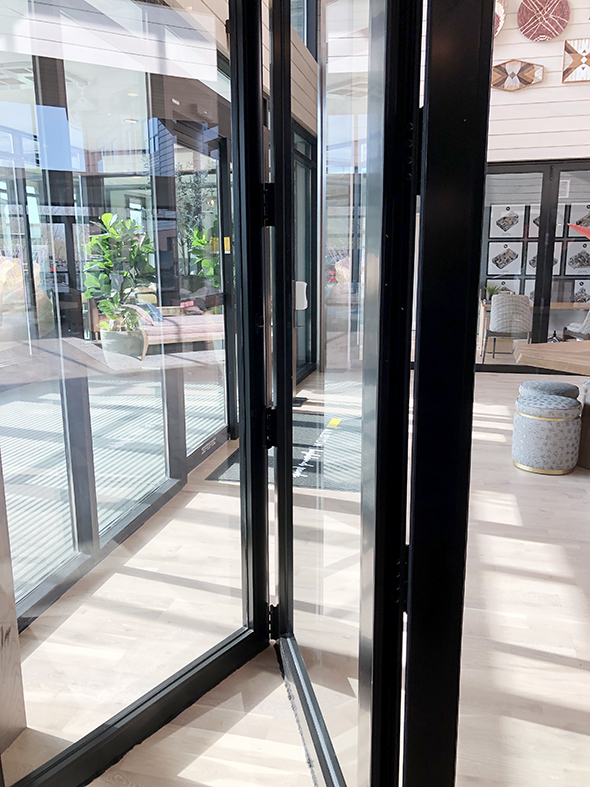 Two bifold door systems with two-point locking handle details