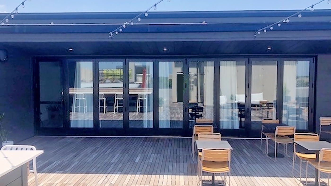 One nine-panel bifold door system and one three-panel multi-track sliding glass door system