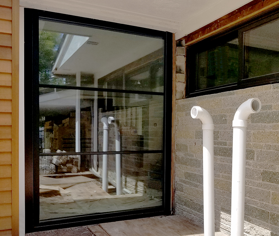 Nine aluminum curtain walls, three with integrated casement windows and two with integrated French Doors. One Sliding glass door an one French Door, each with horizontal grids.