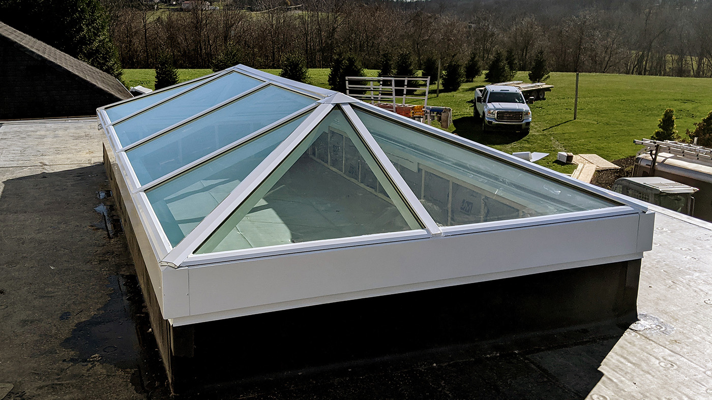 Straight eave double pitch skylight with two hip ends