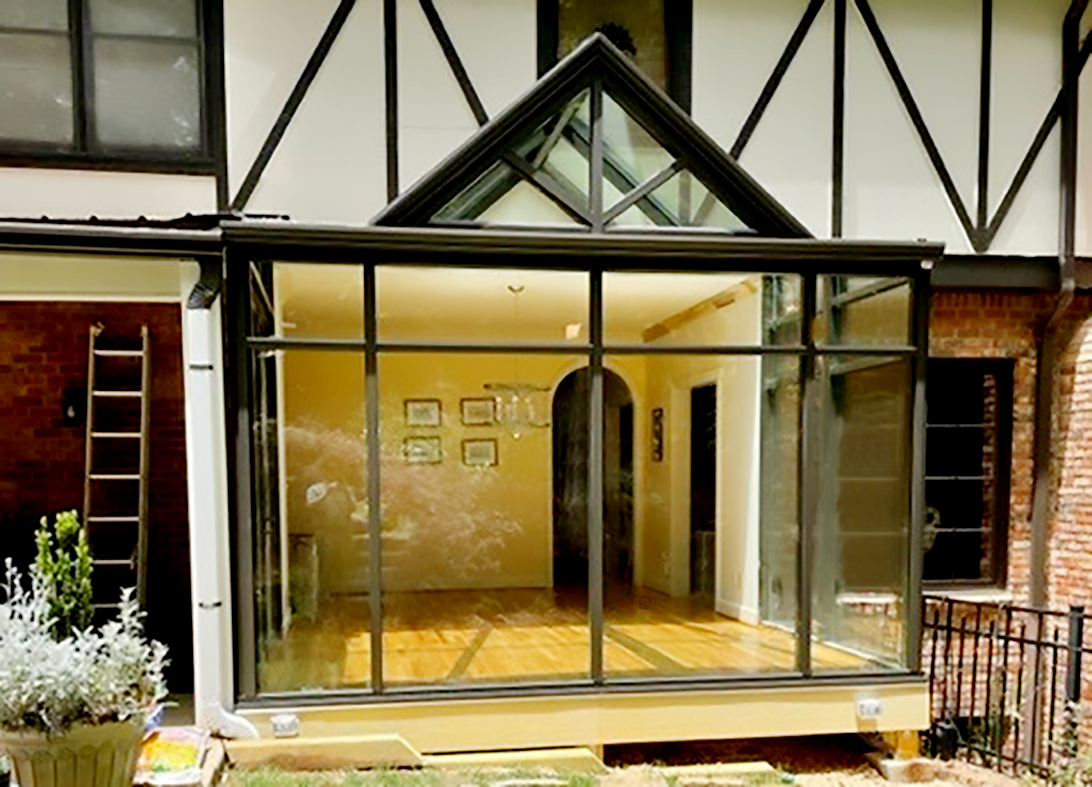 Straight eave lean-to sunroom with a dormer and integrated French door.