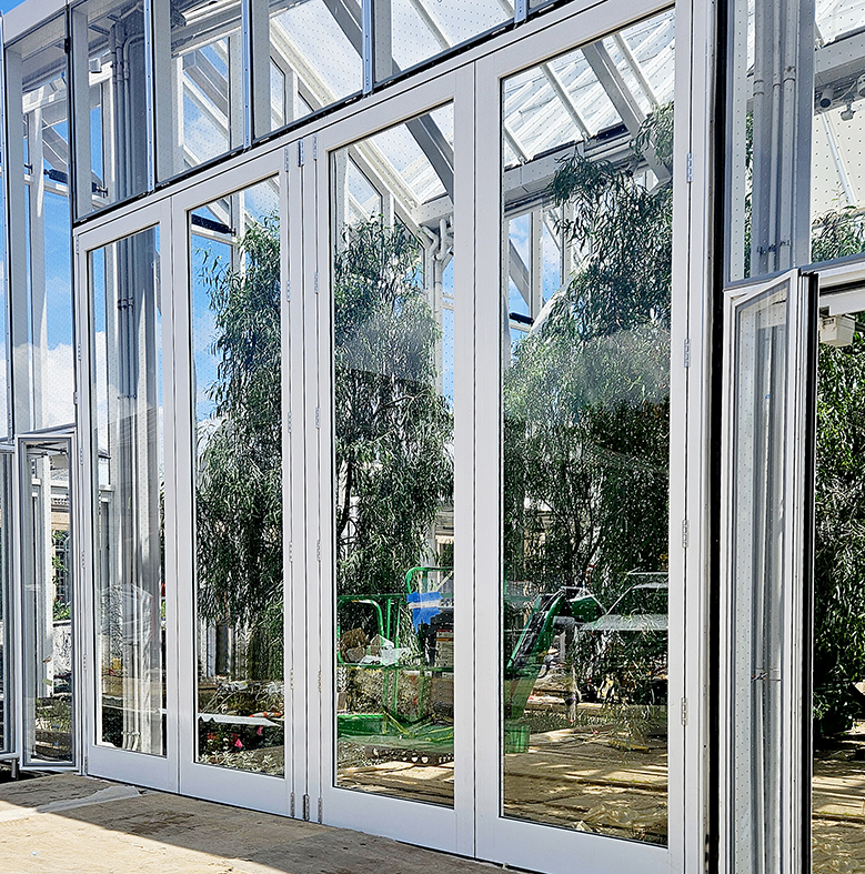 One four-panel G3 outfold split-wall 15 ft. tall bifold door unit with bird-safe glass with a dotted pattern throughout.