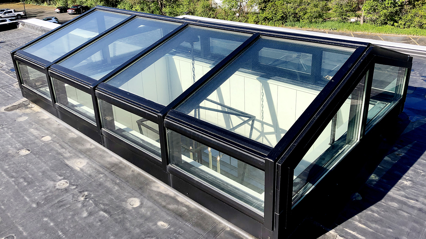 Straight eave double pitch skylight with a transom